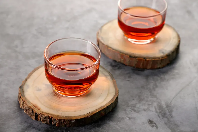Two glass cups of amber Klara Tea